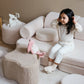 Happy girl sitting on Cream White Play Sofa made by Wigiwama