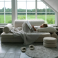 Child reading on the Wigiwama Cream White Settee in a cosy room with large windows and countryside view.