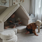 Kids playing and reading inside a fort made from the Wigiwama Cream White Settee and pouffe.